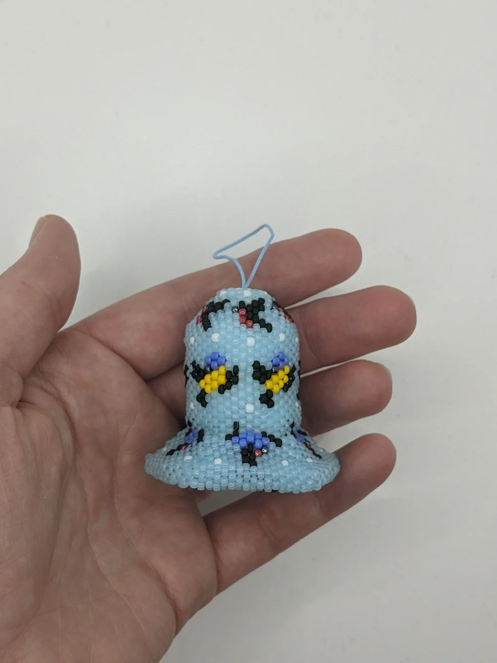 Handcrafted Light Blue Beaded Bell Ornament with Floral Accents